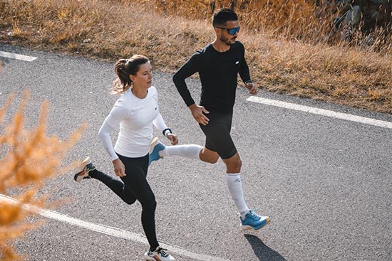 Coureur et coureuse avec des vêtements BV Sport